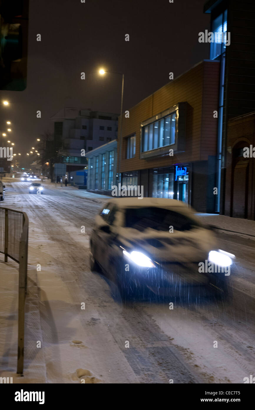 Wagens auf schneebedeckten Straßen in der Nacht Stockfoto