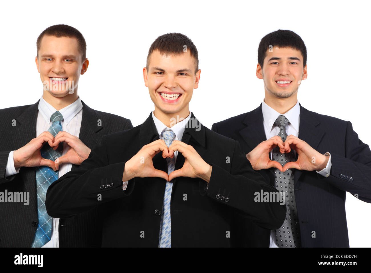 Drei junge lächelnde Geschäftsleute zeigen Liebe Zeichen von Händen Stockfoto