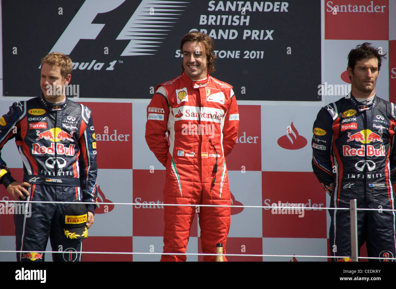 Fernando Alonso feiert gewann den britischen Grand Prix 2011 mit Sebastian Vettel und Mark Webber Stockfoto