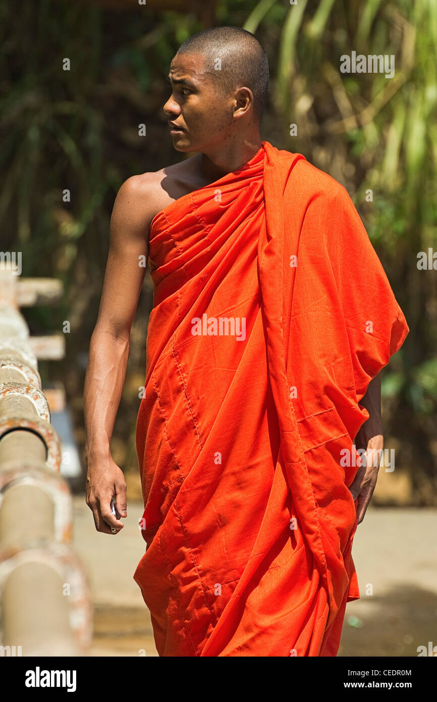 Buddhistischer Mönch in orange Gewand an Rawana (Ravana) fällt, eine beliebte Sehenswürdigkeit auf der Autobahn durch Ella Gap; Ella, Sri Lanka, Asien Stockfoto