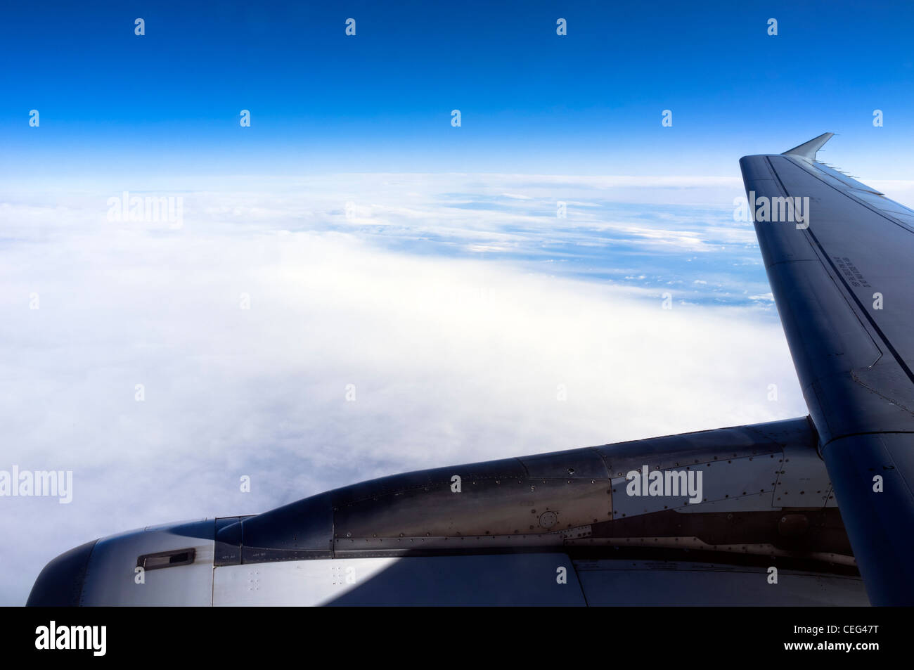 Blick durch das Kabinenfenster an die Flügel eines Flugzeuges im Flug Stockfoto