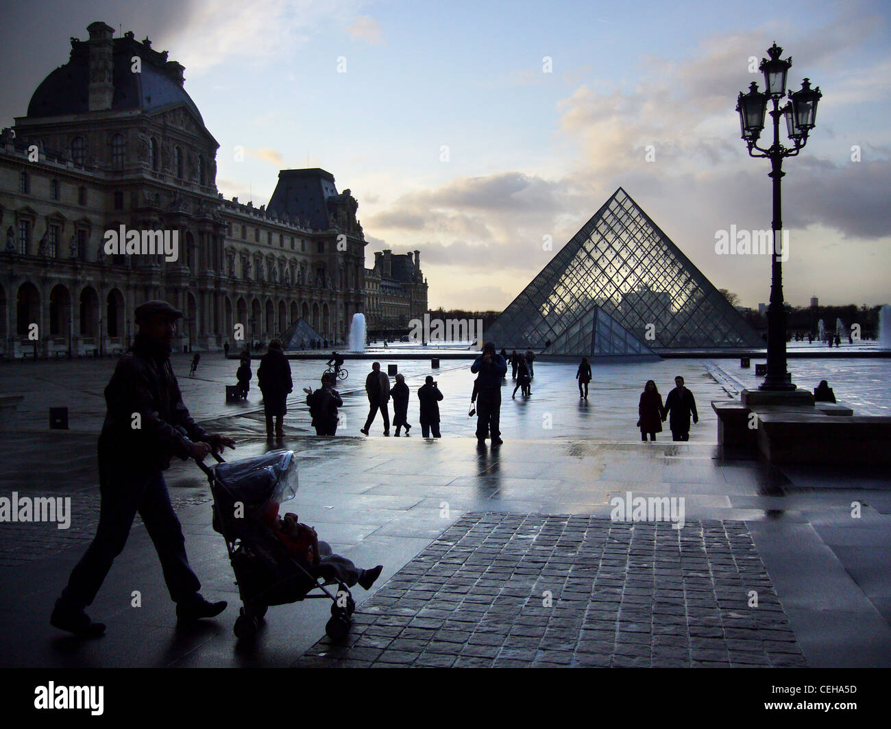 Silhouetten an einem regnerischen Tag in Place du Carrousel du Louvre, Paris, Frankreich Stockfoto