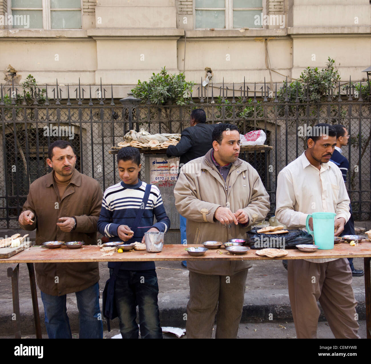 Männer und jungen Essen am Straßenrand stand, Kairo, Ägypten Stockfoto