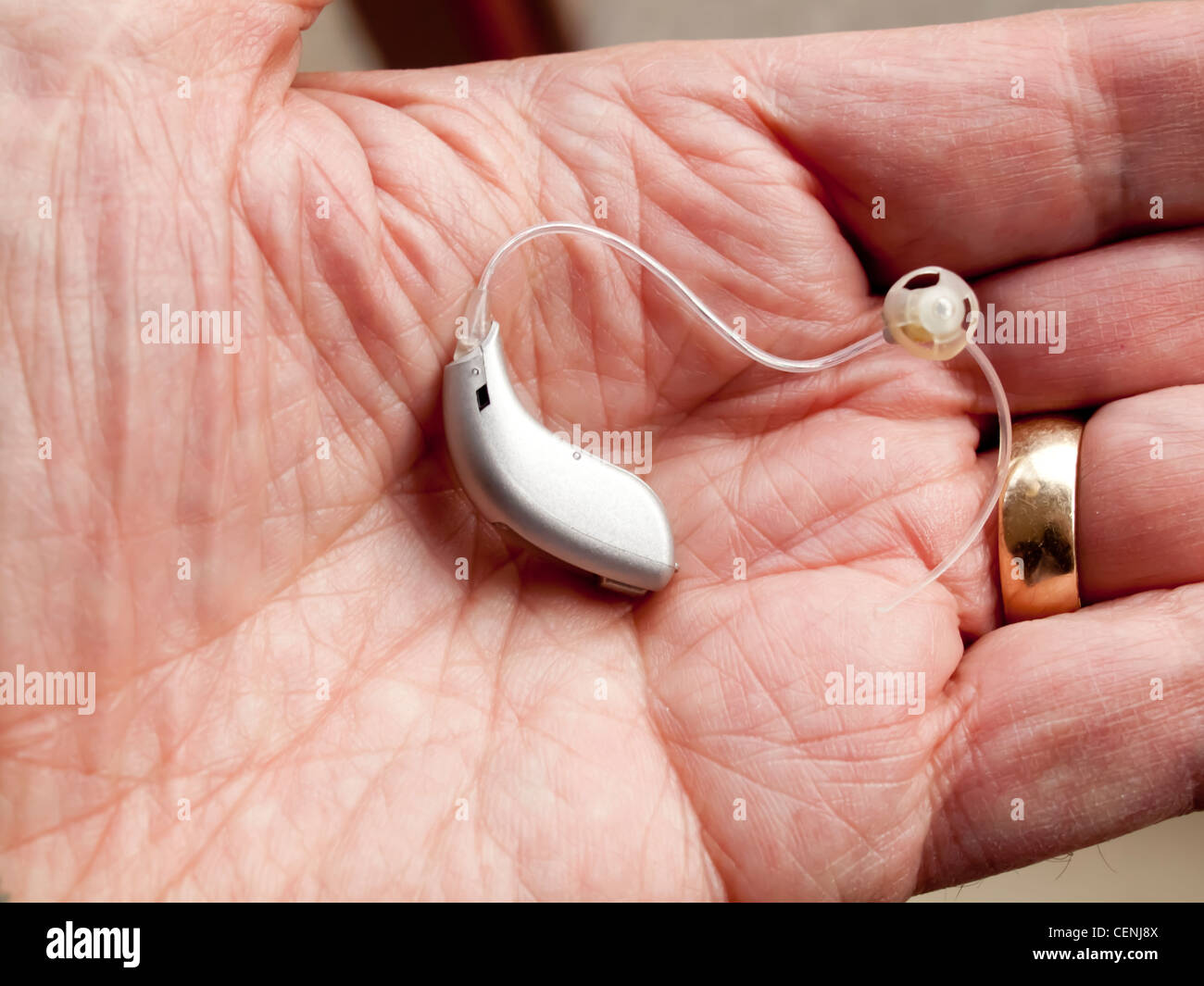 Eine teure Miniatuarised Hörgerät gezeigt auf einem mans Hand Stockfoto