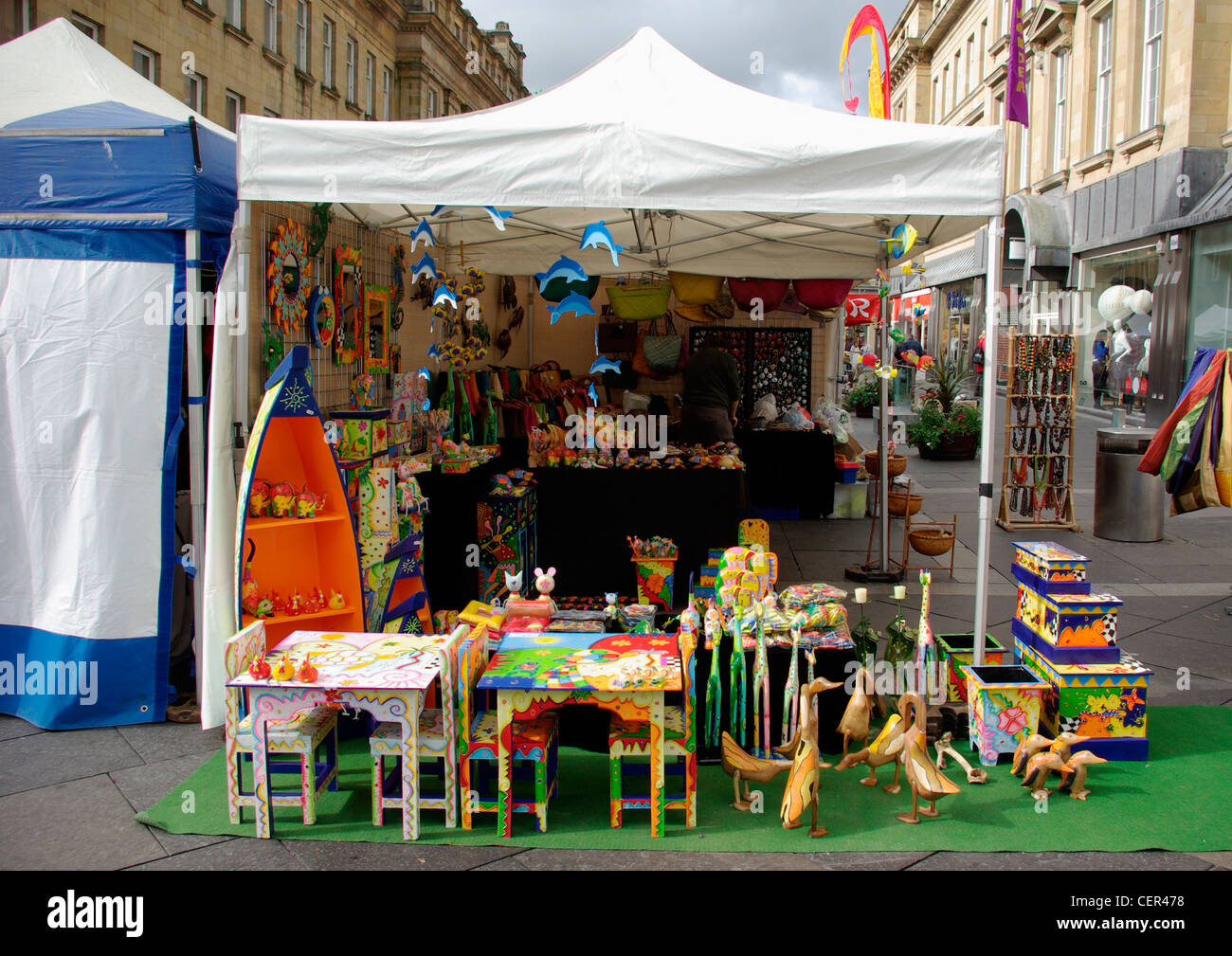 Bunte Marktstand verkauft Holzspielzeug im Stadtzentrum von Newcastle. Stockfoto