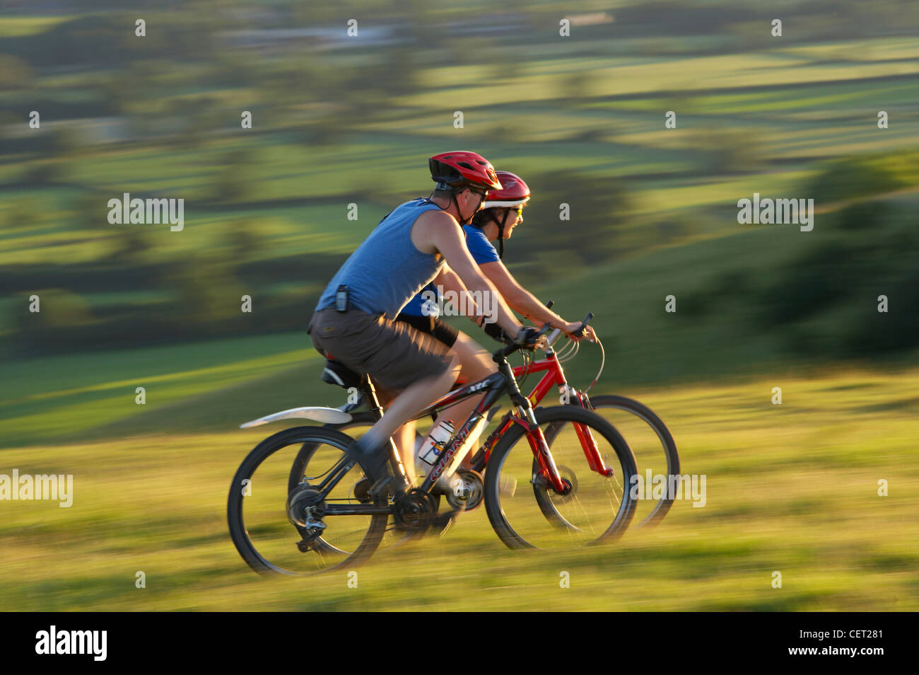 Mann & Frau auf dem Mountainbike Radfahren auf Hambledon Hill über die Blackmore Vale, Dorset, England, UK Stockfoto