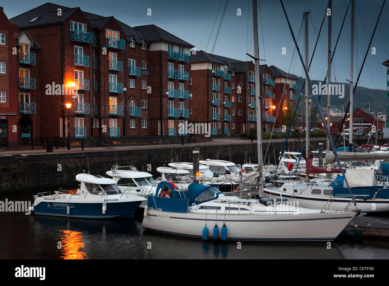 Großbritannien, Wales, Swansea, Seeviertel, Yachten ankern in der Marina neben Apartments am Wasser in der Nacht Stockfoto