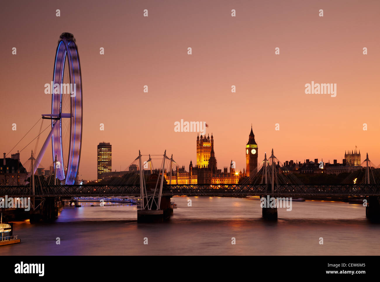 Den Blick entlang der Themse der Millennium Wheel (London Eye), Houses of Parliament und Big Ben bei Sonnenuntergang, London, UK Stockfoto