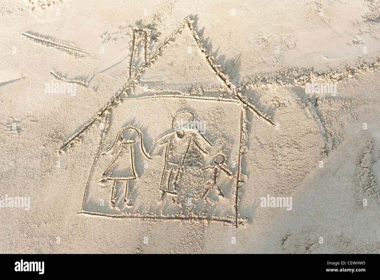 Zeichnung der Familie im eigenen Haus in Sand, erhöhte Ansicht Stockfoto