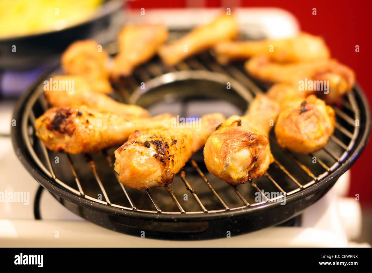 Hühnerkeulen auf einem Grill auf Gas-Herd Stockfotografie - Alamy