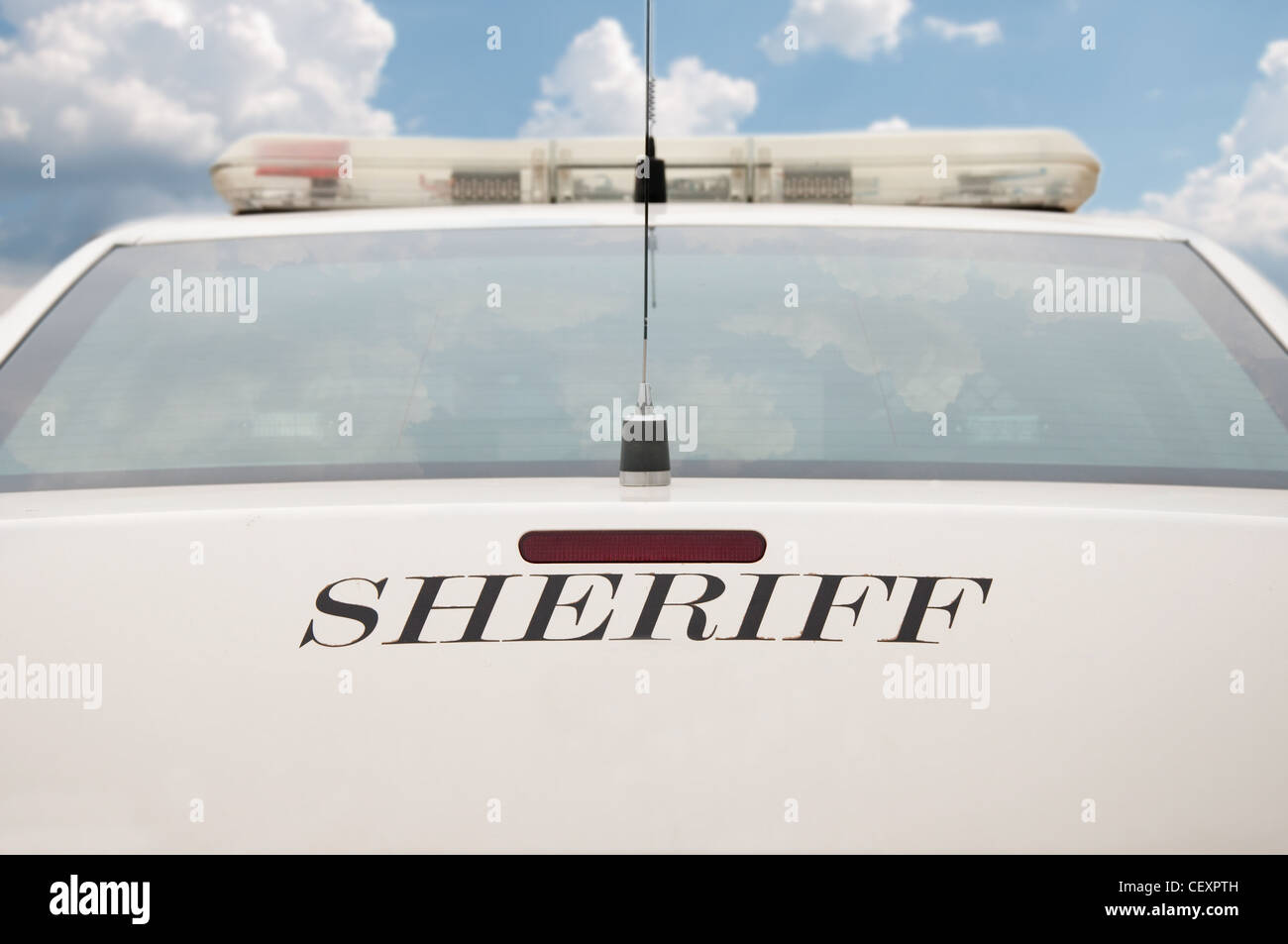 Hintere Ende des Sheriffs Streifenwagen mit bewölktem Himmelshintergrund Stockfoto
