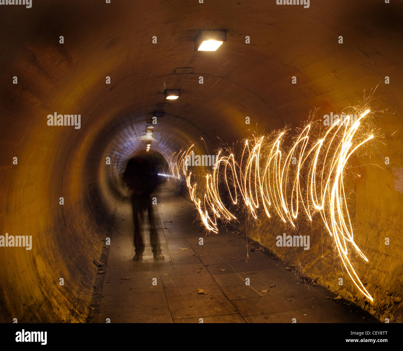 Ein Mann in einem unterirdischen Tunnel bei Nacht, tunnelvision Vision, die einen Weg des Lichts schafft Stockfoto
