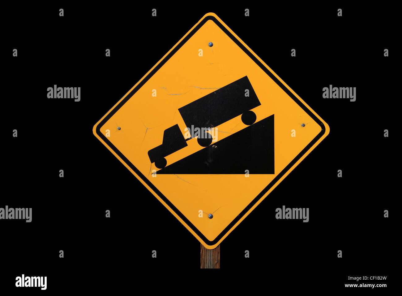 steile Straße Zeichen mit einem LKW fahren auf einer steilen Herabstufung in schwarz und gelb auf schwarzem Hintergrund Stockfoto