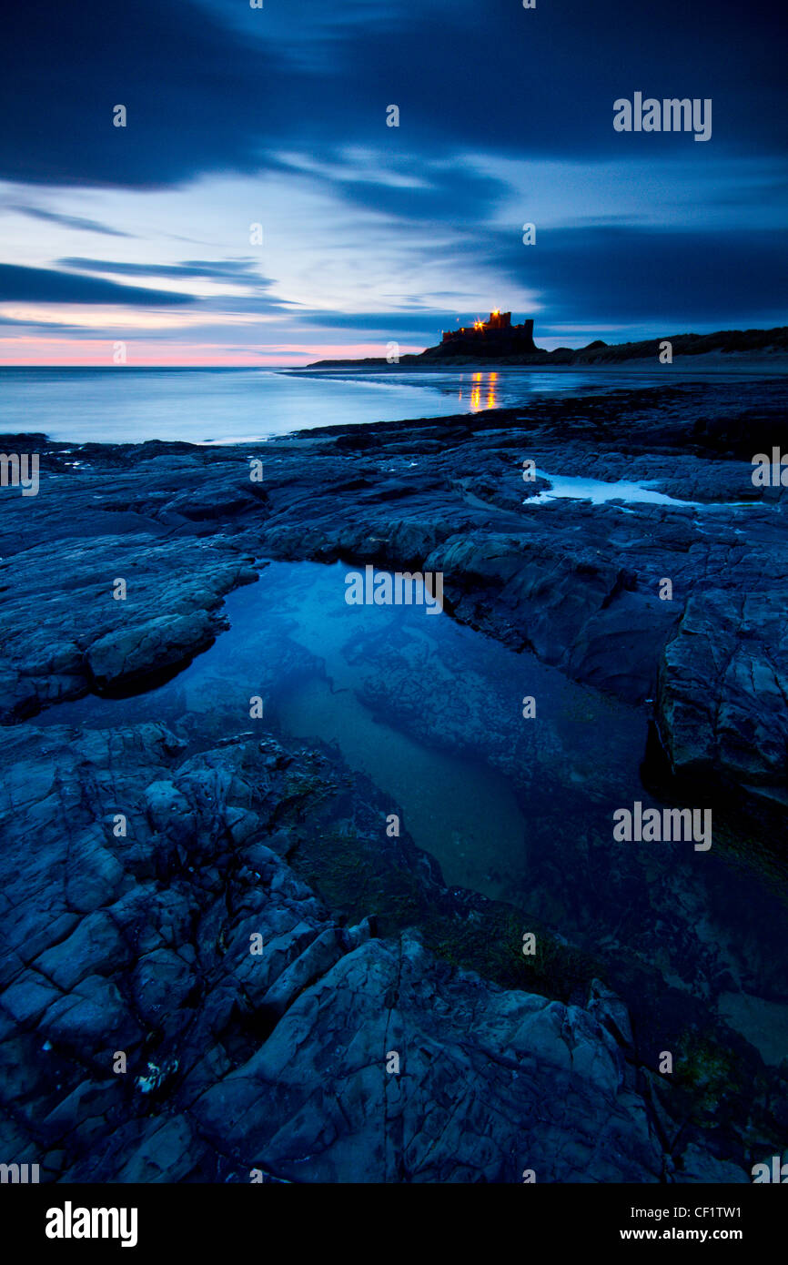 Bamburgh Castle, eines der berühmtesten Gebäude der Northumberland kurz vor Sonnenaufgang. Stockfoto