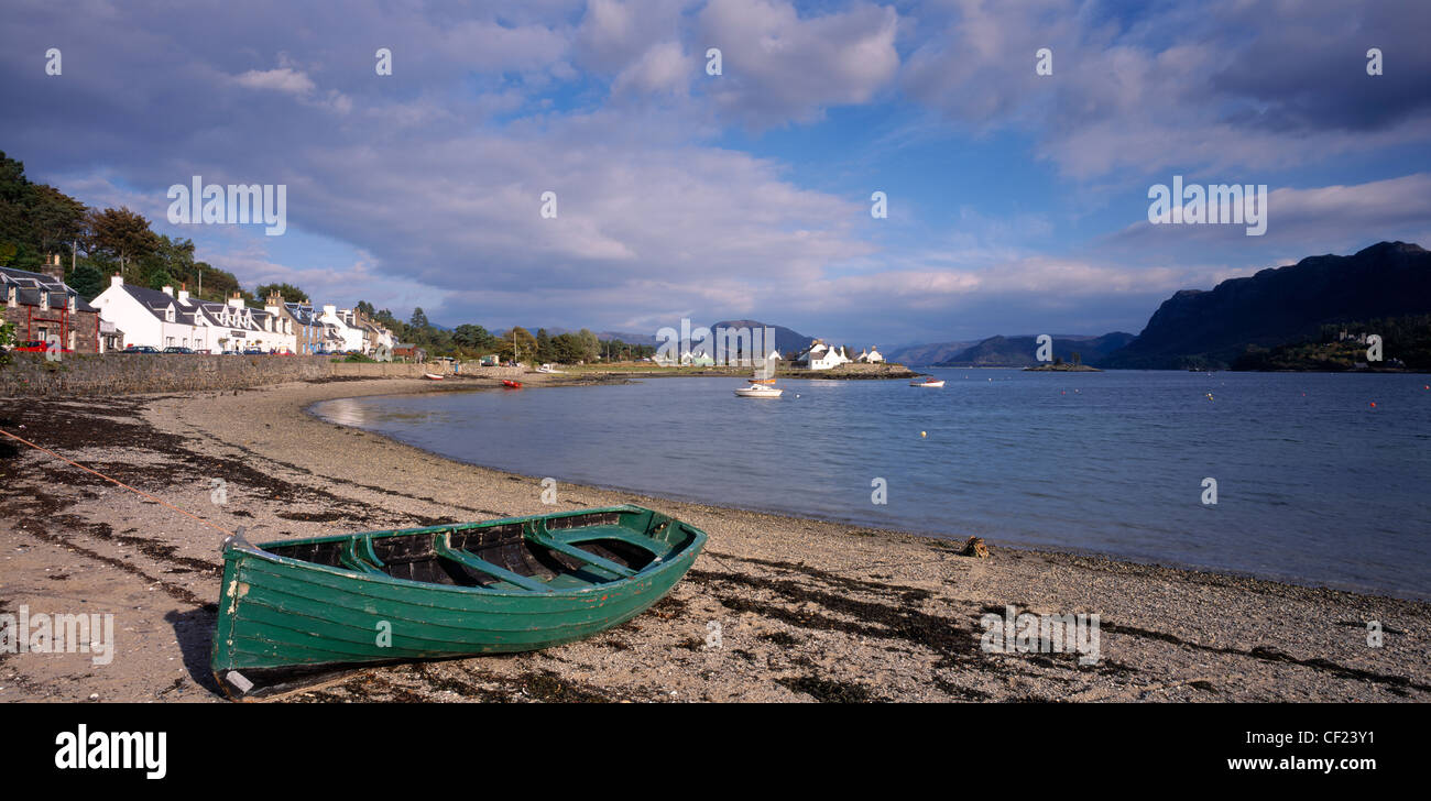 Grüne Boot auf einem Strand von Plockton, Highland, Schottland, UK. Stockfoto