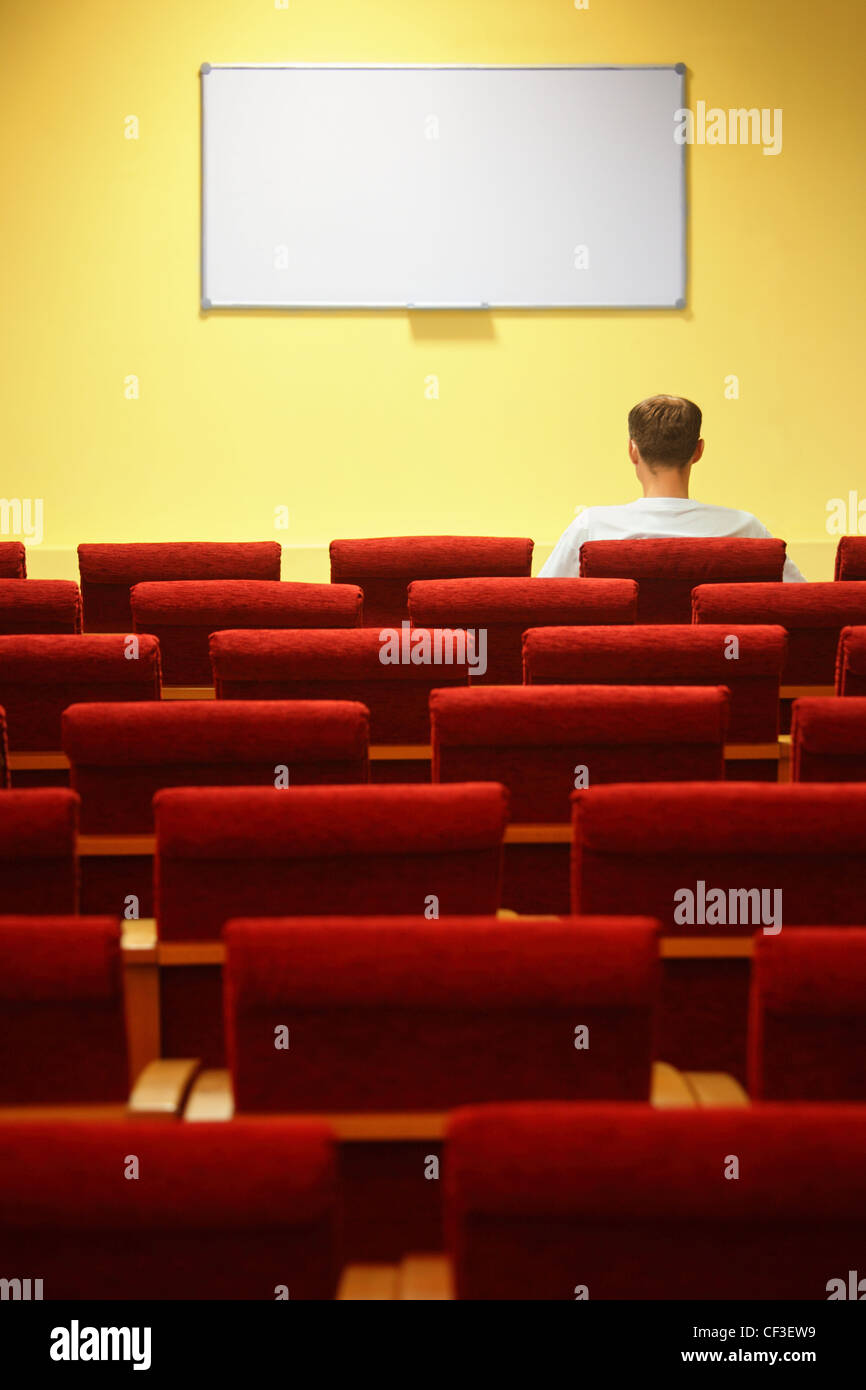 leere Konferenzsaal. ein Stuhlreihen. konzentrieren Sie sich auf eine erste Zeile. ein Mann sitzt im Stuhl Stockfoto