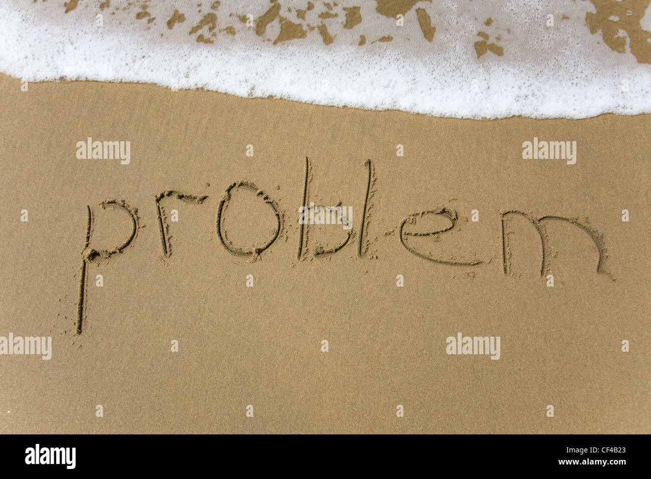 Handschrift-Textaufgabe in den Sand geschrieben Stockfoto