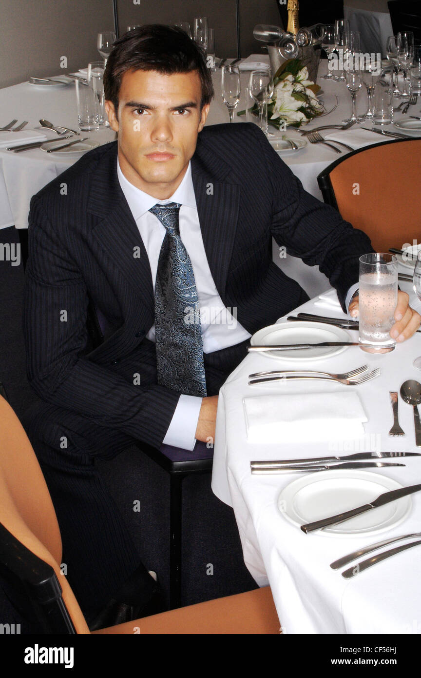 Männchen tragen schwarzen Anzug, weißes Hemd, graue Krawatte mit Glas  Wasser am Tisch sitzen Stockfotografie - Alamy