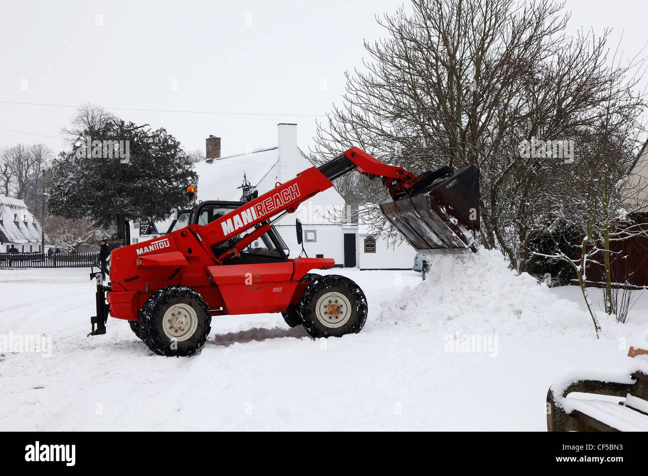 Bagger dumping Schnee Milton Cambridgeshire Stockfoto