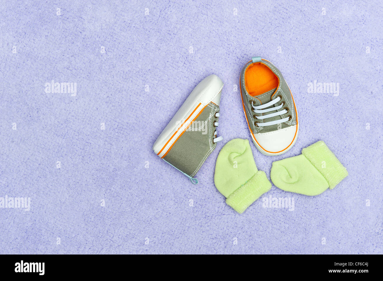 Ein paar Kinder Baby-Schuhe und Socken auf einer flauschigen Decke lila. Stockfoto