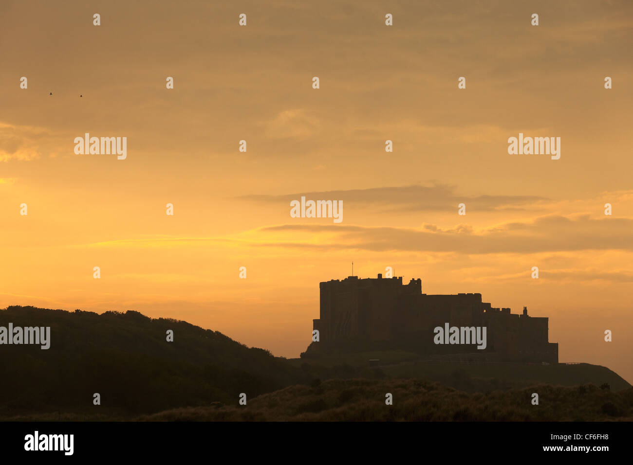 Silhouette eines Gebäudes bei Sonnenuntergang; Bamburgh Northumberland, England Stockfoto