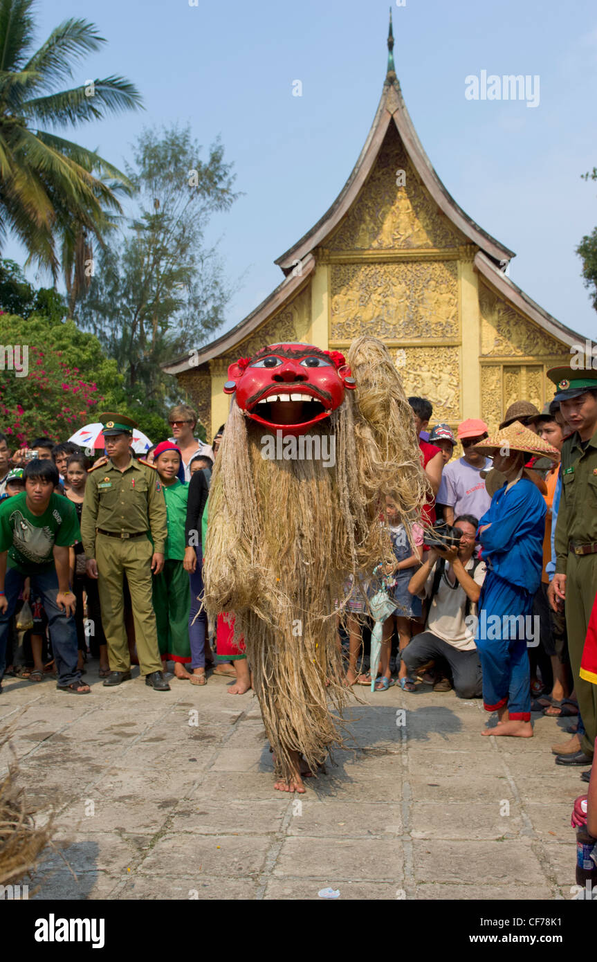 Maskierte Pou Nyer einen legendären Vorfahren der Lao Menschen tanzen vor der goldenen Sim an Wat Xieng Thong auf Mue Nau, der mittlere Tag der Lao Neujahr (Pi Mai Lao), Luang Prabang, Laos Stockfoto