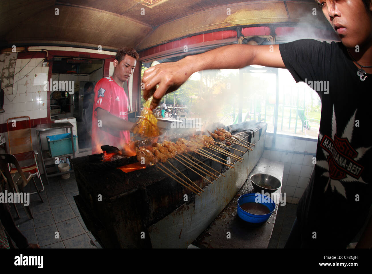 Die beiden Malaien Vorbereitung ein lokales Gericht Satay. Stockfoto