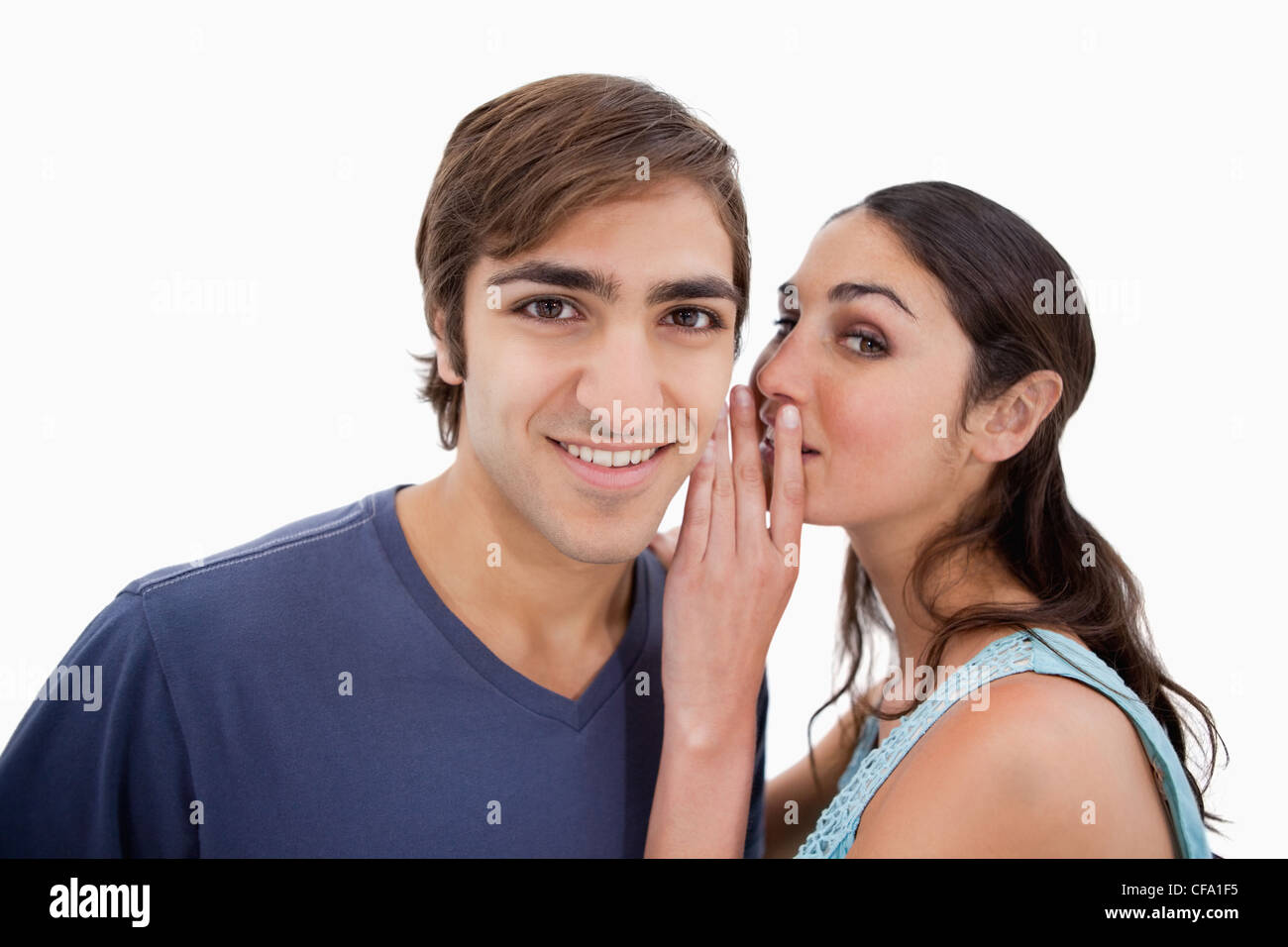 Junge Frau etwas zu ihrem Verlobten Flüstern Stockfoto