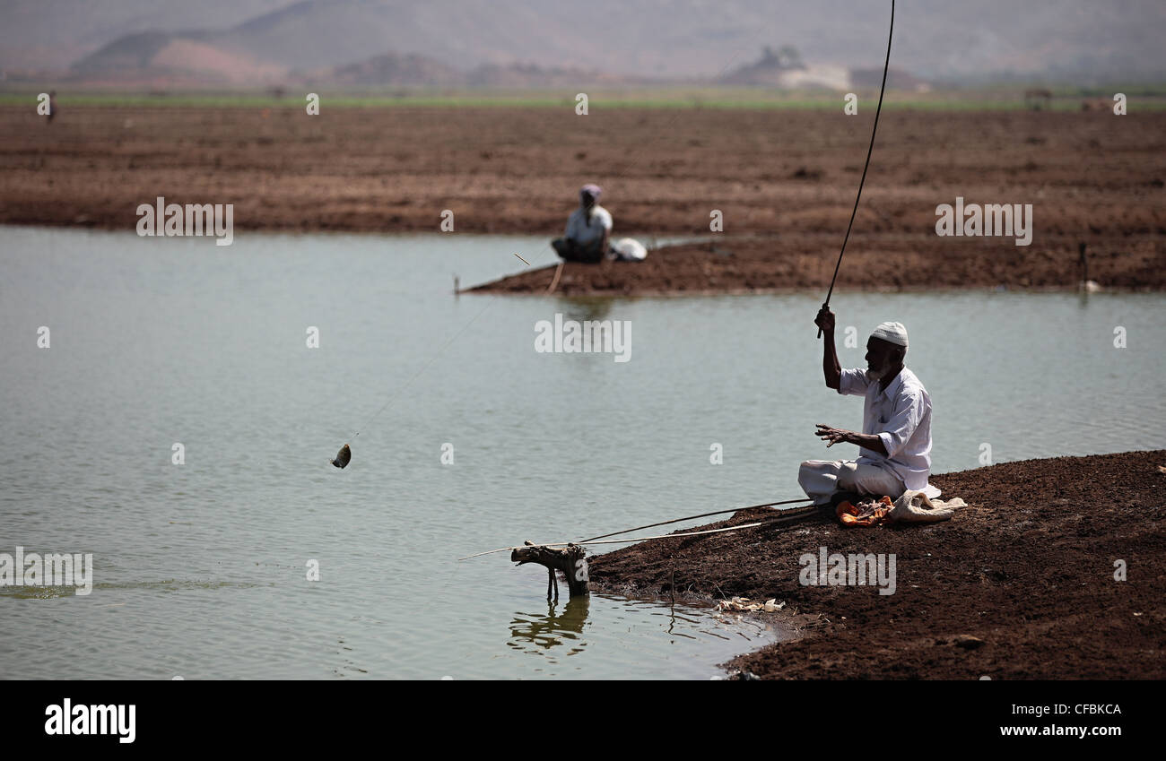 Ländliche Fischer nur fangen einen Fisch aus einem kleinen Teich Andhra Pradesh in Indien Stockfoto