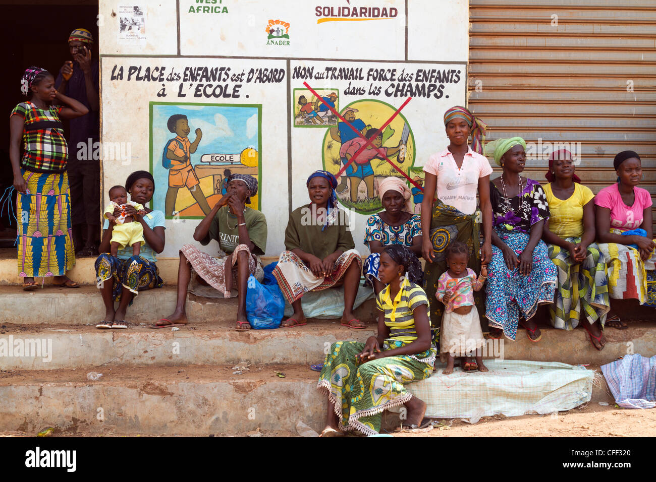 Frauen, die darauf warten, Bohnen, Kakao vor einem Publikum zu sortieren beachten Sie wieder die Kinderarbeit, Duekoue, Elfenbeinküste, Westafrika Stockfoto