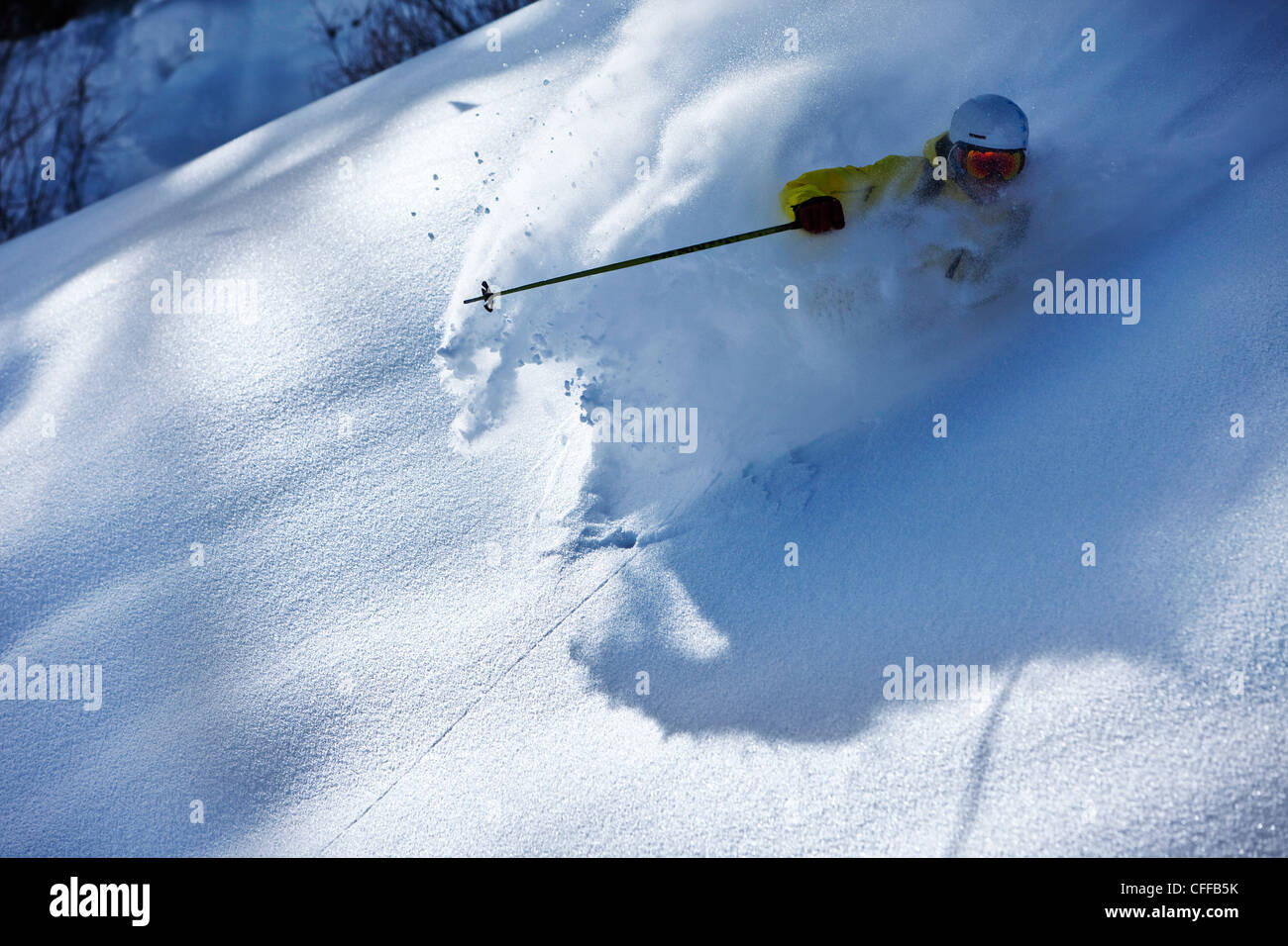 Ein sportliche Skifahrer reißt Frischpulver abwechselnd an einem sonnigen Tag in Colorado. Stockfoto