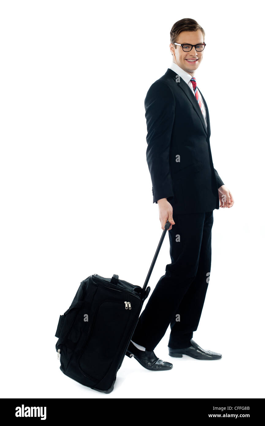Corporate Person for Business-Besprechung verlassen, wie er sein Gepäck schleppt Stockfoto