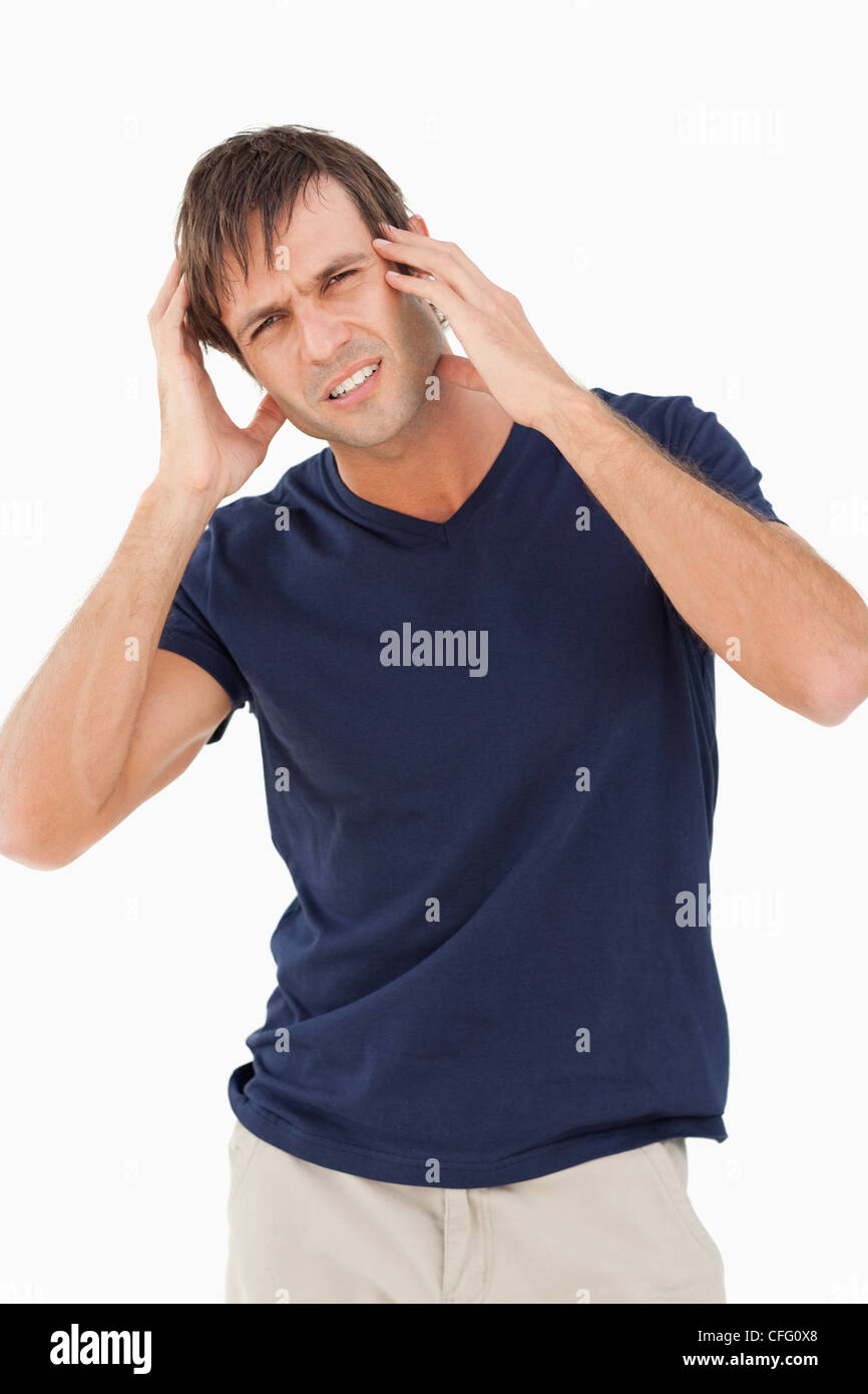 Man schaut in die Kamera und zeigt ein Kopfschmerz Stockfoto