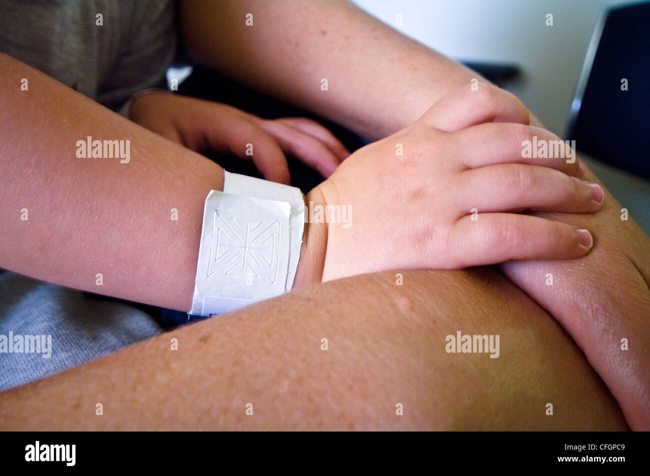 Eine jungen kleinen Hand ruht auf seiner Mutter Arm für Komfort nach der Operation. Stockfoto