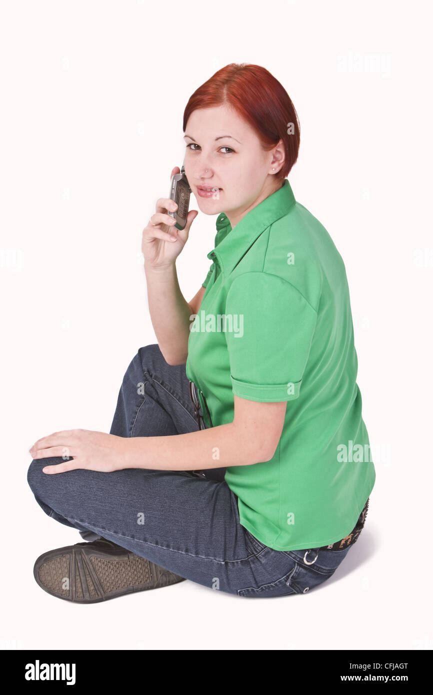 Bild von einem Rothaarige Teenager-Mädchen mit einem Mobiltelefon. Stockfoto