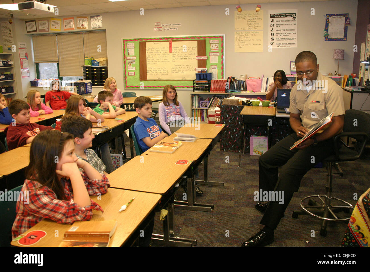 Yeoman Seaman Teylor Ottress, von der Navy Expeditionary Logistics Support Group, Naval Weapons Station Yorktown-Cheatham Annex, liest vor Studenten der DJ Montague Elementary School im Rahmen von Read Across America, dem Geburtstag des Kinderautors Dr. Suess. Seit 2009 betreut die NAVESLG-Seeleute die Schüler der Schule. Stockfoto