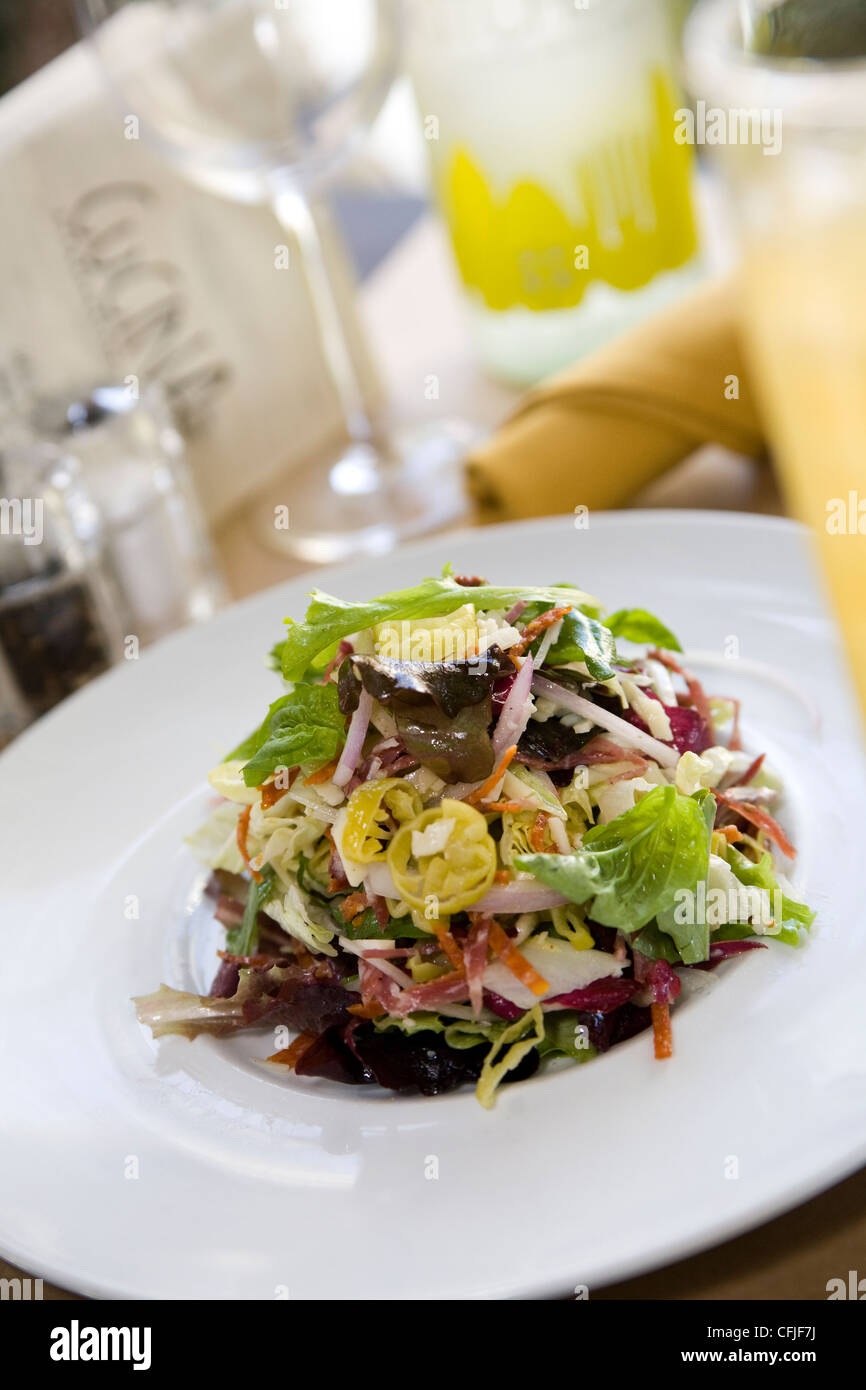 Frischen gehackten Salat auf einem hellen weißen Teller in ein modernes café Stockfoto