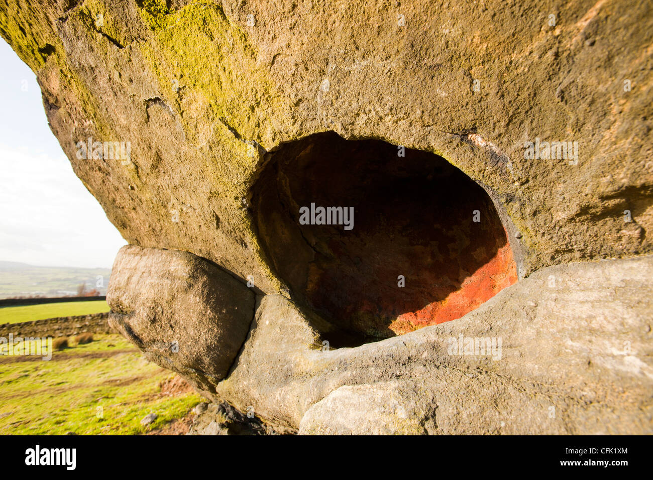 Ein Findling Mühlstein Korn auf Ilkley Moor mit einem perfekten runden Loch vermutlich durch eine große Aufnahme gebildet Stockfoto