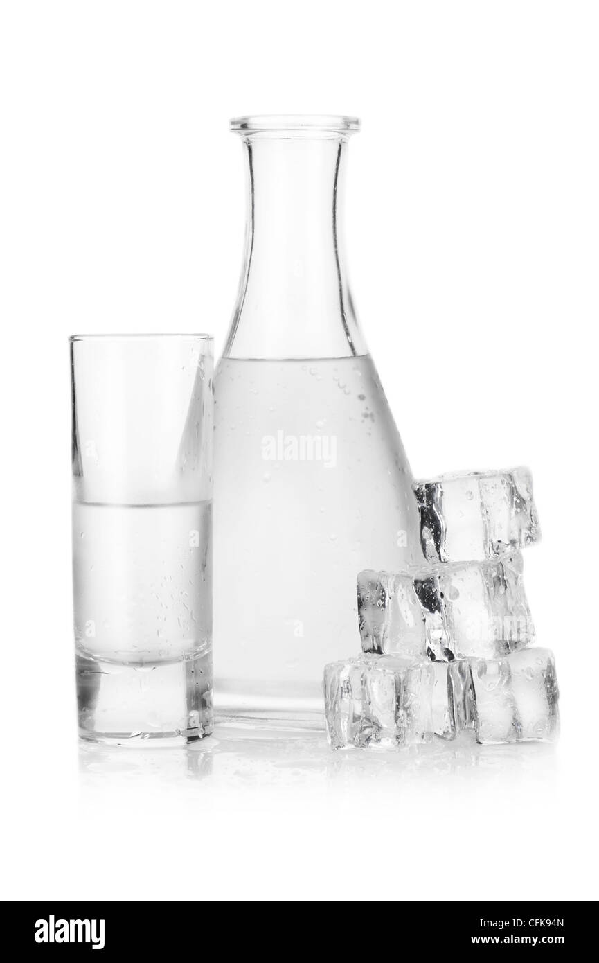 Dekanter und Glas eisgekühlten Wodka mit Eiswürfeln auf weißem Hintergrund Stockfoto