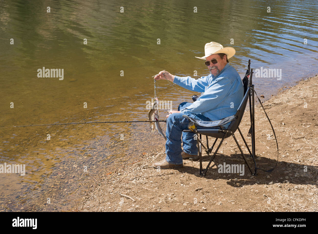 Hispanic Mann zeigt einen feinen Stringer Forellen gefangen am See Bonito, Lincoln National Forest, Ruidoso, New Mexico. Stockfoto