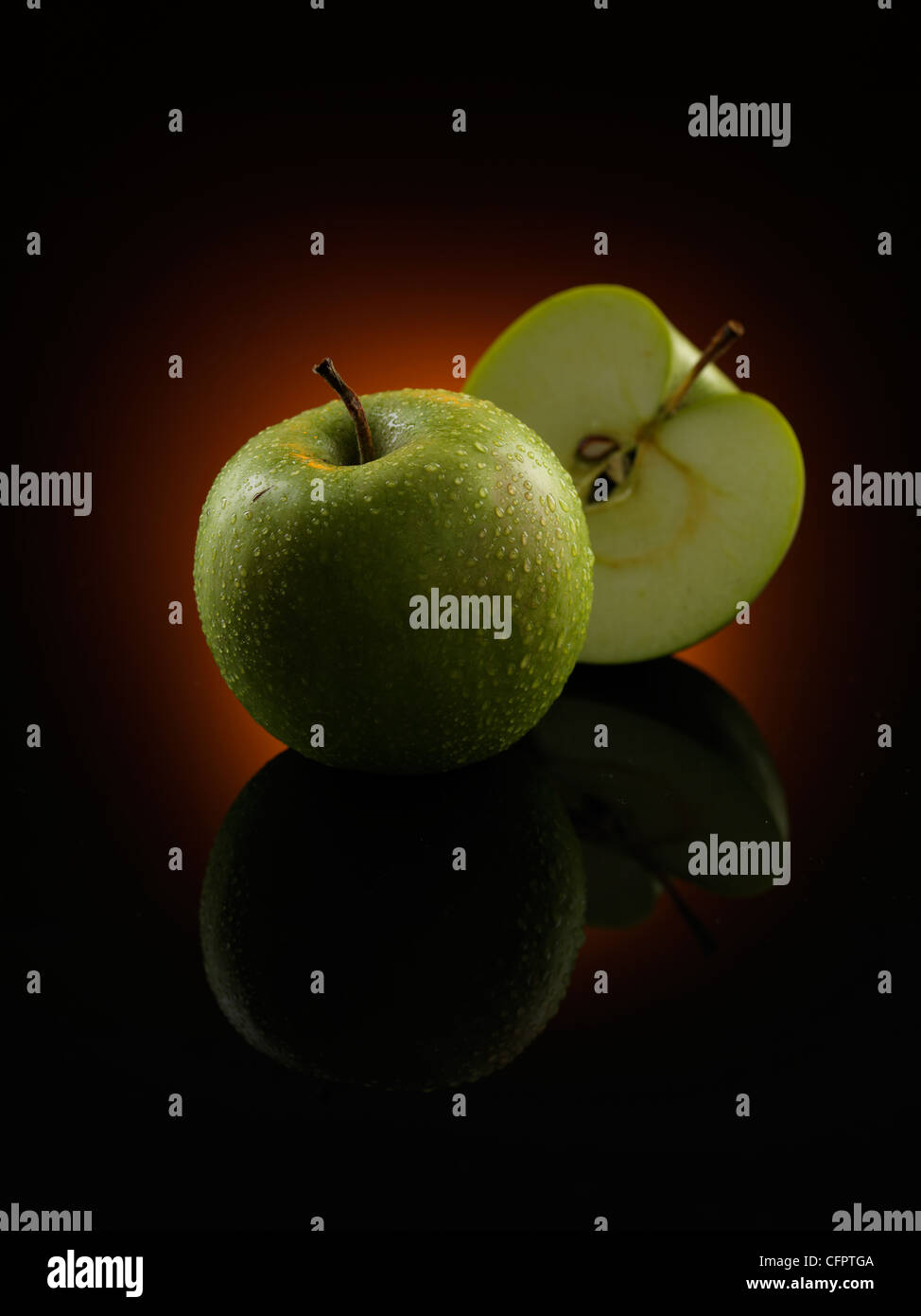 Dies ist ein großer Apple-Foto mit schwarzem Hintergrund und orangefarbenes Licht. Stockfoto