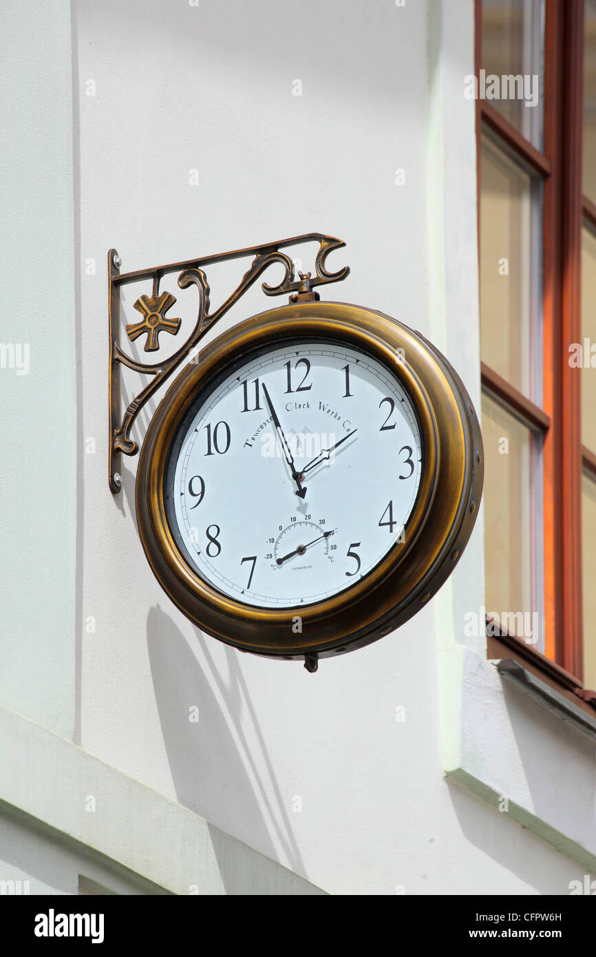 alte Runde Straße Uhr an einer weißen Wand hängen Stockfoto