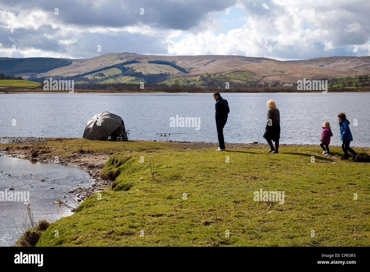 Fischer, Männer & Frauen, grober Fischer Mann unter Tarnschirm auf Lake Semerwater, North Yorkshire Dales und National Park, Wensleydale, Großbritannien Stockfoto
