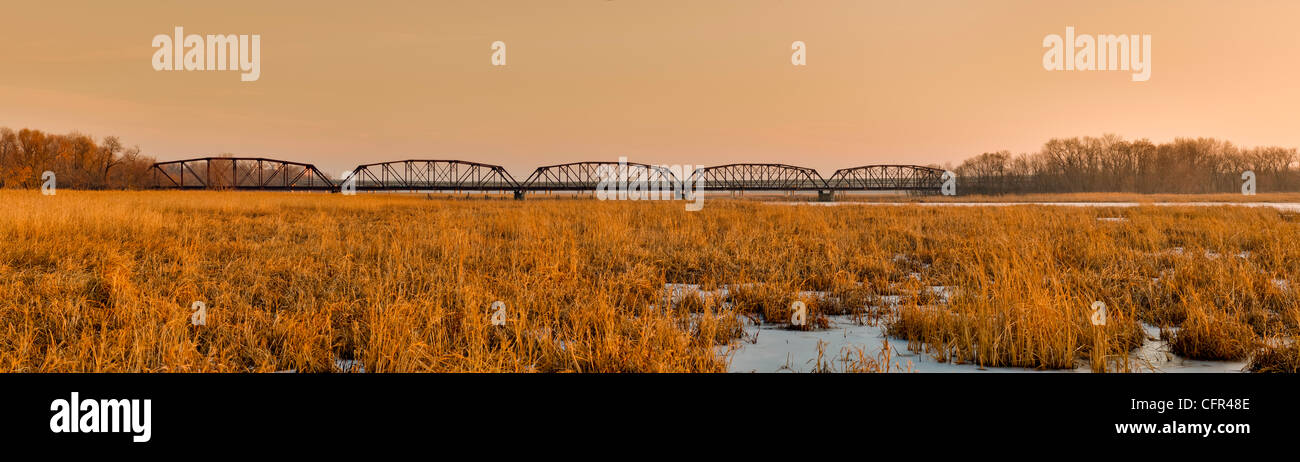 Sunrise beleuchtet alte Zeder Straßenbrücke, wie gesehen von der Promenade in Minnesota Wildlife Refuge Stockfoto