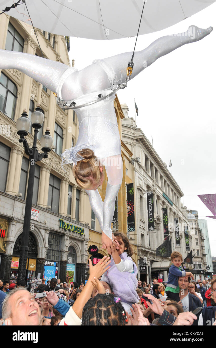 Piccadilly, London, UK. 2. September 2012. Ein Performer abzuhängen aus einem Ballon hängt kopfüber. Die "Piccadilly Circus Circus" Veranstaltung rund um Piccadilly, wo die Straßen voll von Zirkusartisten, Regent Street und Piccadilly geworden sind für den Verkehr gesperrt und mit kostenlosen Veranstaltungen gefüllt. Stockfoto