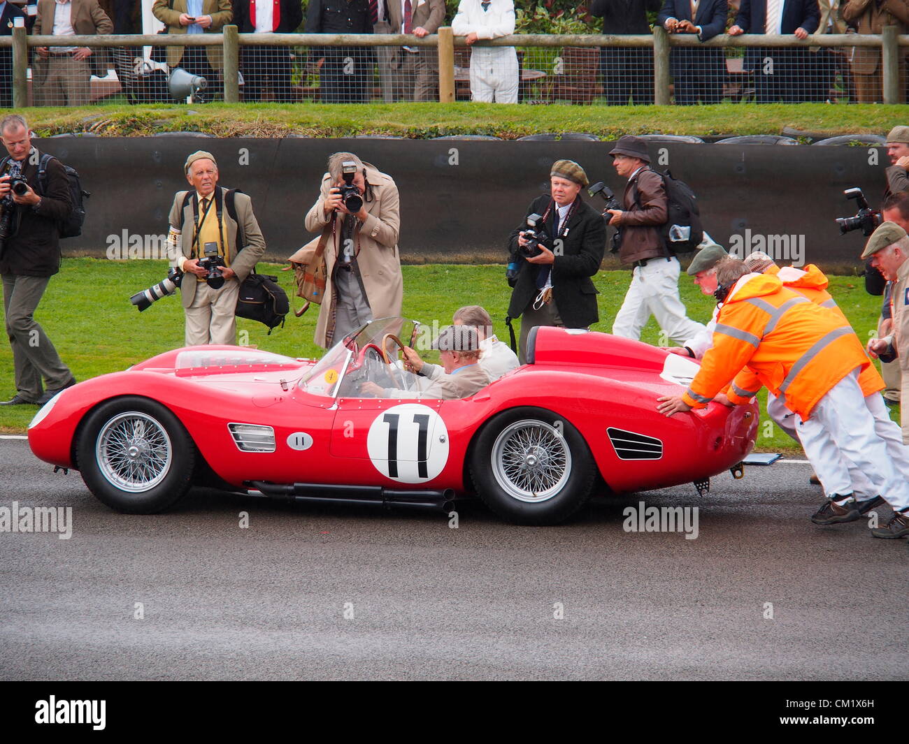 Goodwood Revival Praxis Tag Freitag September 14th.2012. Historischen Rennsport Autonummer 11 mit Fahrer und Beifahrer bekommt Anschieben auf der Strecke, umringt von Fotografen. Stockfoto