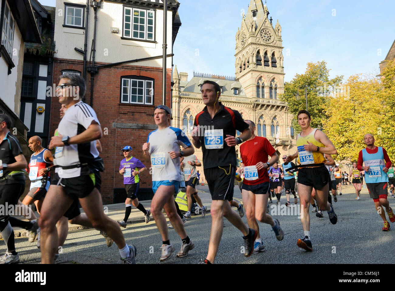 7. Oktober 2012, Chester UK. Kurz nach dem Start des Marathons MBNA Chester passieren die Läufer vor dem Rathaus und entlang der St Werburgh Street. Stockfoto