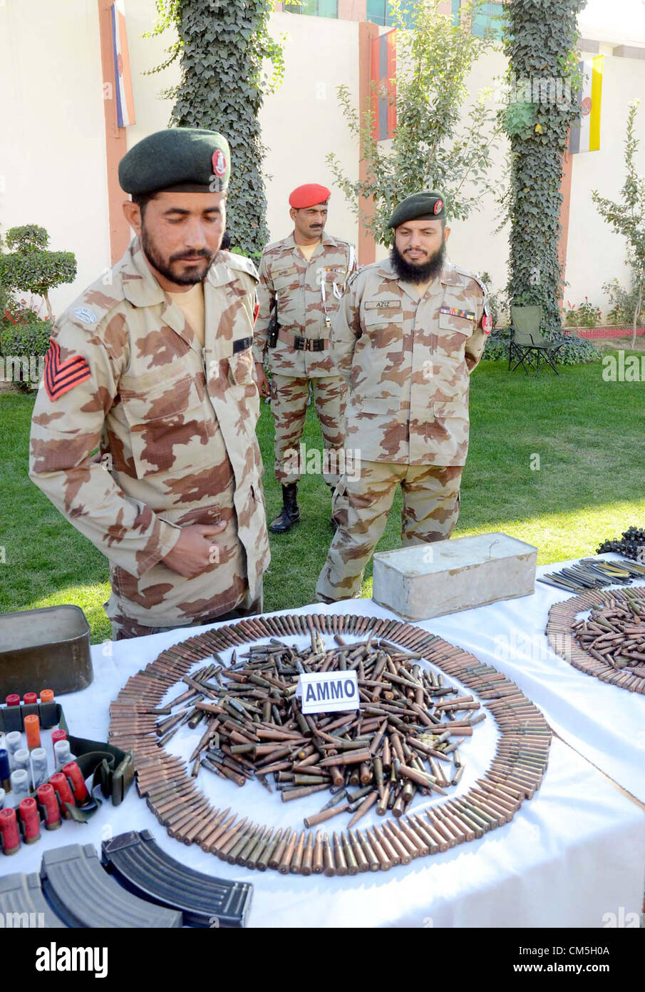 Frontier Corps Beamten zeigen beschlagnahmten Waffen, Kugeln und gefälschte Fahrzeuge Nummernschilder, die bei einer Razzia am Rinde Garh Ostumgehung im Kommandobereich, während einer Pressekonferenz am FC-Hauptsitz in Quetta am Dienstag, 9. Oktober 2012 geborgen wurden. Stockfoto