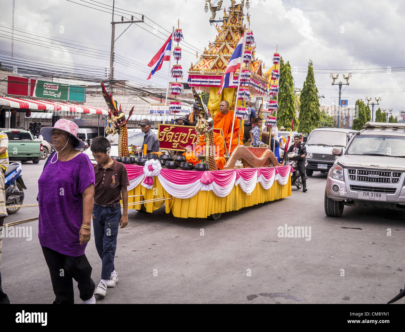 31. Oktober 2012 - Yala, Yala, Thailand - Thai-Buddhisten ziehen einen buddhistischer Mönch auf eine Parade Float durch Yala für Ok Phansa. OK Phansa markiert das Ende der buddhistischen "Verliehen" und fällt auf den Vollmond des elften Mondmonats (Oktober). Es ist ein Tag der fröhlichen Feier und Verdienst-Herstellung. Für die Mitglieder des Wat Kohwai, in Yarang Bezirk von Pattani war es ein noch spezieller, denn es war das erste Mal in acht Jahren, die sie Ok Phansa feiern konnten. Die buddhistische Gemeinschaft ist umgeben von muslimischen Dörfern und es wurde zu gefährlich, die ausgelassene Feier wegen der Musli halten Stockfoto