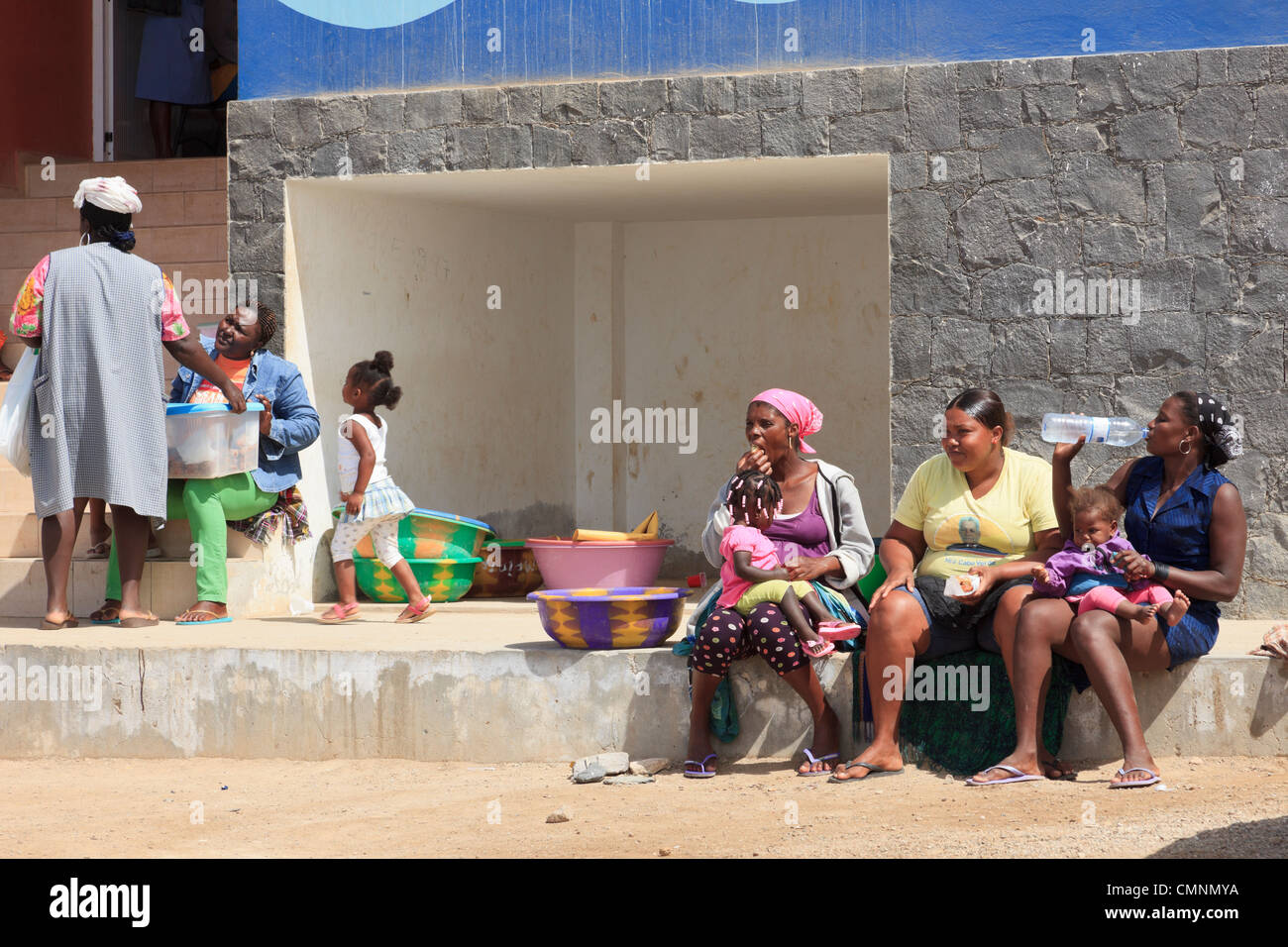 Einheimische Frauen außerhalb der städtischen Fischmarkt mit einer Frau, die in Flaschen abgefülltes Wasser zu trinken. Sal Rei Boa Vista Kapverdische Inseln. Stockfoto